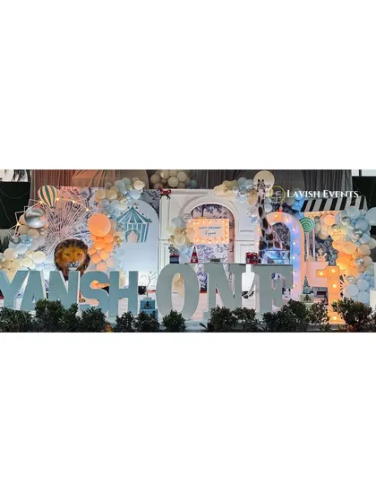 The main stage for Kiyansh's carnival party, featuring large 3D letters spelling "KIYANSH ONE" and a soft, dreamy color palette.