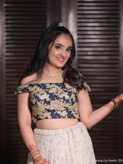 A youthful and trendy party look, featuring a high half-ponytail and a sparkling off-the-shoulder top. The makeup is fresh and glam, perfect for a teen or young adult.