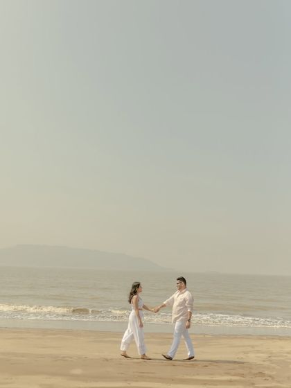 A wide shot emphasizing the scale and tranquility of the beach. This minimalist approach creates a serene and cinematic feel for your pre-wedding photos.