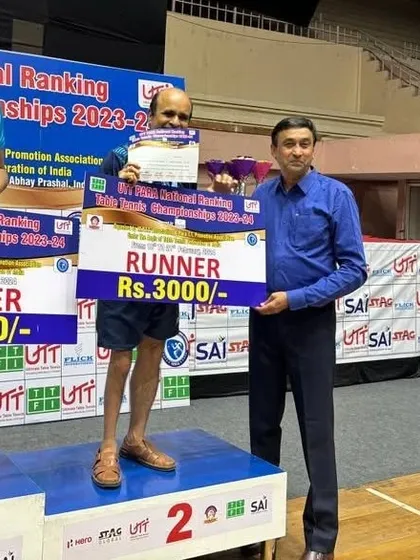 Gajanan Parmar on the podium receiving his runner-up prize money for his silver medal performance in the singles event at the PARA National Rankings.