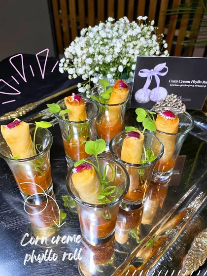 Corn Creme Phyllo Rolls served in individual shot glasses with a dipping sauce. An elegant and mess-free way to enjoy a crispy appetizer.