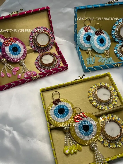 Our cute Diwali combo boxes are a perfect gift. Each box contains two decorative tea light holders and a pair of beaded evil eye 'Shubh Laabh' hangings for beauty and prosperity.