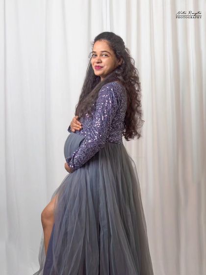 This image shows the versatility of a single session. We moved from a moody, dark setup to a clean, bright white background to provide a variety of looks with the same beautiful gown.