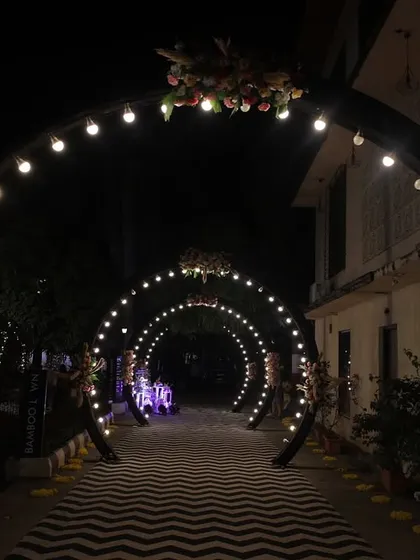 The full view of the light-bulb archway, creating a tunnel of light for the couple's entrance. This is a simple yet highly effective way to make a grand statement.