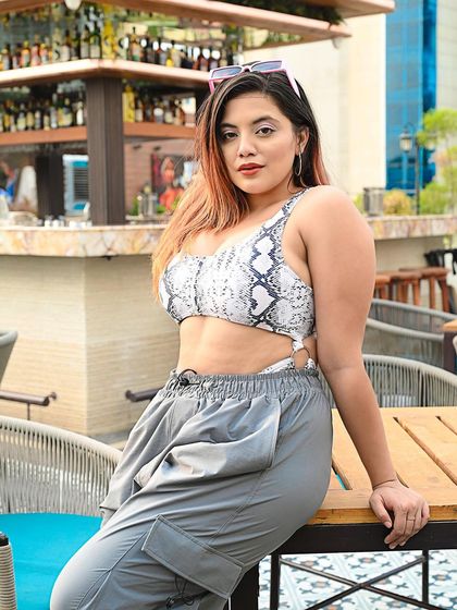 A street style shot of an influencer at a cafe, looking chic and confident. This is great for brand collaborations and lifestyle blogs.
