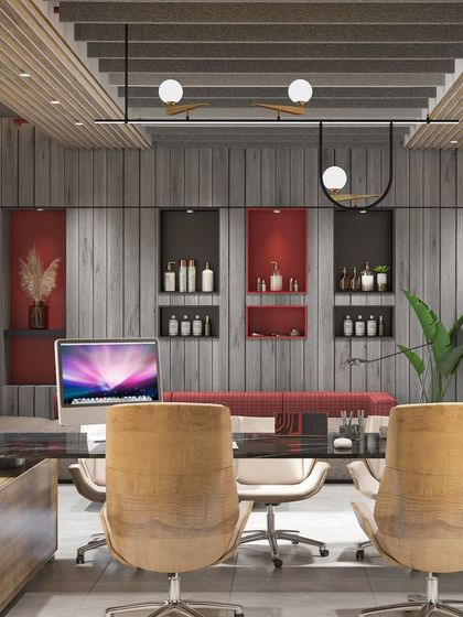 This executive cabin for Unique Labels uses a mix of wood textures and a bold red accent niche. The design provides a comfortable seating area for informal discussions.
