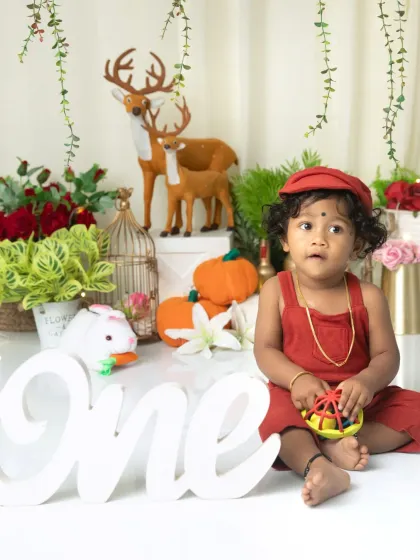 A different take on the festive theme with a bold red outfit. This little one is ready to celebrate his first birthday surrounded by holiday cheer.
