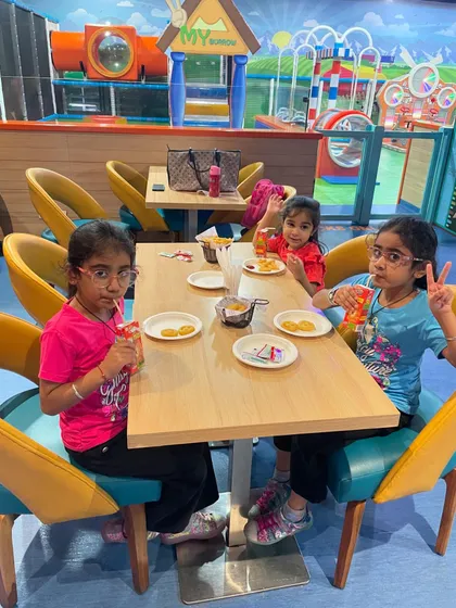 Friends taking a break from playing to enjoy snacks and drinks at the Snack Box cafe.