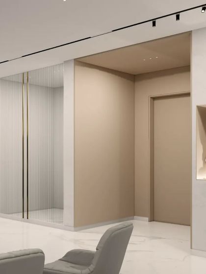 An entryway concept for the Gulecha Residence, where art and architecture merge. A niche for a statement sculpture and a gallery wall for photographs personalize the space, while a fluted glass partition offers a hint of the rooms beyond.