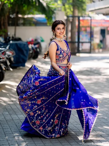 Here’s one of our clients looking absolutely radiant for her mehendi. This royal blue lehenga features intricate floral embroidery, and the way it moves is just magic. It’s the perfect blend of traditional craft and modern energy.