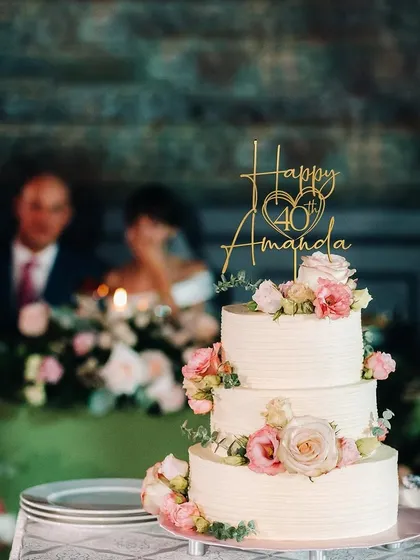 This "Happy 40th Amanda" topper is captured in a real party setting, showing how it becomes a beautiful focal point of the celebration.