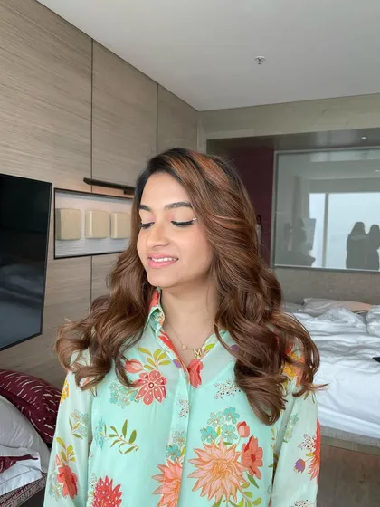 A close-up of the soft waves and minimal makeup, showing a natural and radiant look suitable for any daytime event.