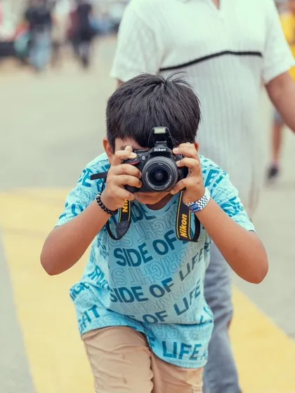 We are inspiring the next generation of Vroomers. A young fan with a camera captures the action, showcasing the family-friendly and aspirational nature of our festival.