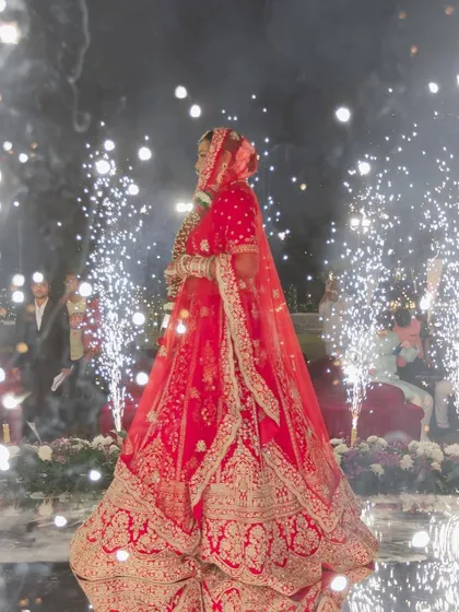 The grand bridal entrance is a moment of pure magic. Bhavika looked absolutely breathtaking, surrounded by sparklers, with her classic red lehenga and radiant makeup making her the star of the night.