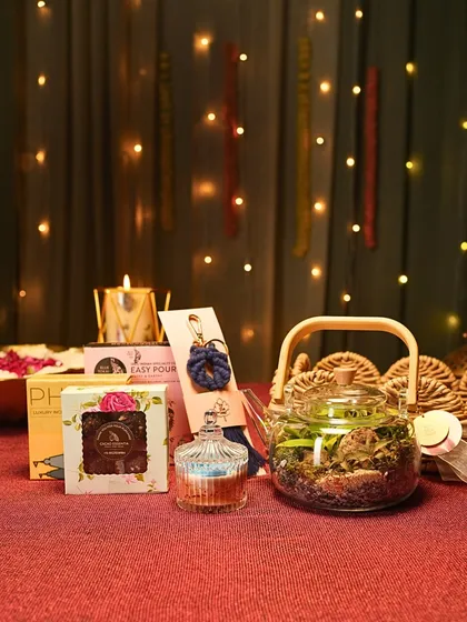 Here you can see the individual elements of my festive hamper coming together. It includes a teapot terrarium, a scented candle, handmade chocolates, and other small treasures to delight the senses.