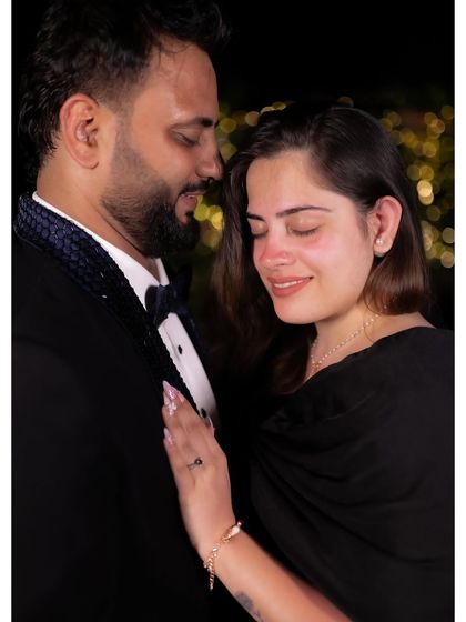 An intimate close-up of the couple during a night shoot, with soft bokeh lights in the background. This shot showcases our ability to create romantic moods even after dark.