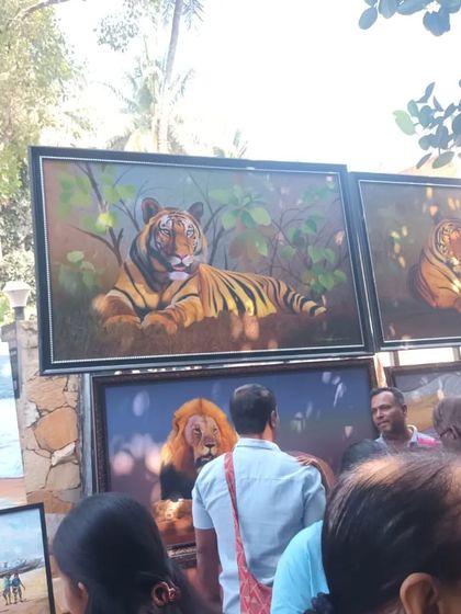 Large, framed paintings of tigers and lions attracting a crowd at the Chithrasanthe. It's always inspiring to see so many people appreciating art.