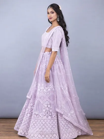 This soft pastel lavender lehenga is the definition of elegance. This side view shows the beautiful flare of the skirt and the intricate white threadwork that covers the entire outfit.
