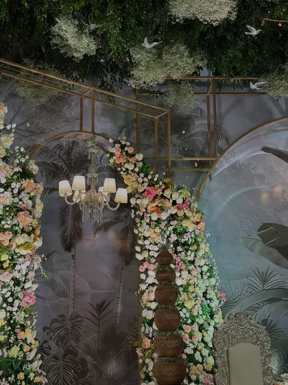 Another angle of the enchanted garden stage, showcasing the interplay of light, florals, and a custom-designed backdrop to create a truly magical setting.