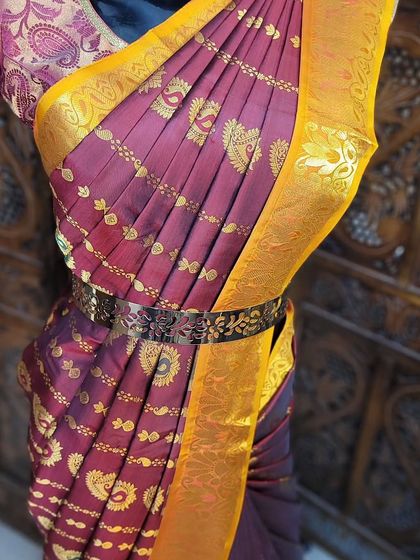 The upper body of the mannequin drape, showing the neatly arranged chest pleats and the addition of a waist belt.