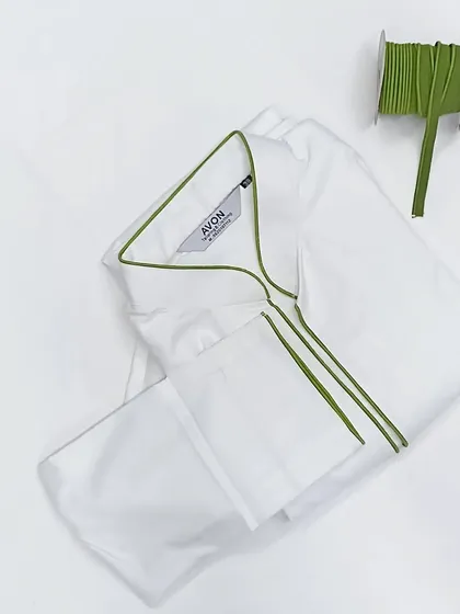 Sometimes, simplicity is the most elegant. This is a classic white saya kurta set, finished with a clean, sharp piping detail in green. I have over 40 different piping colors to choose from.