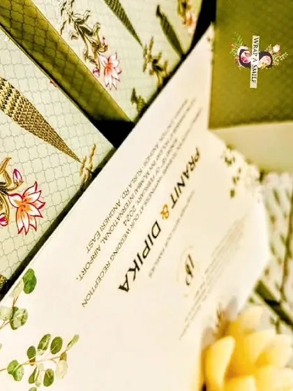 A wedding invitation is the first chapter of your story. This mint green invitation box, featuring a Moroccan design and lotus stem motifs, holds two jars of nuts and a graceful invite, setting a tone of sophisticated elegance for the celebration.