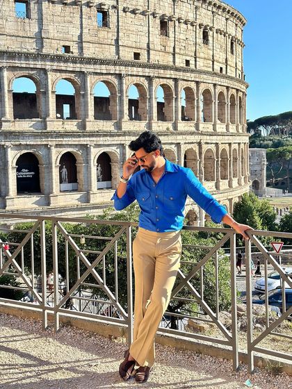 A confident pose in the Viaggio shirt, showcasing its perfect fit and vibrant color that stands out in any setting.