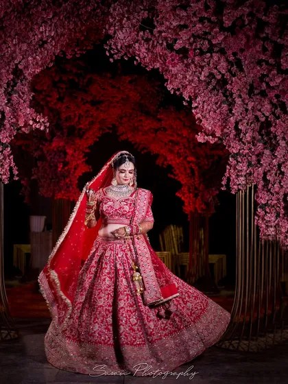 A stunning bridal portrait set against a dramatic floral arch. We use creative lighting and composition to create magazine-worthy images that feel like a fairytale.