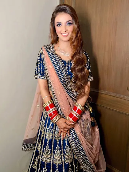 My beautiful reception bride looking absolutely radiant. Her royal blue lehenga is paired with a striking blue smokey eye and a flawless complexion, perfect for her grand celebration.