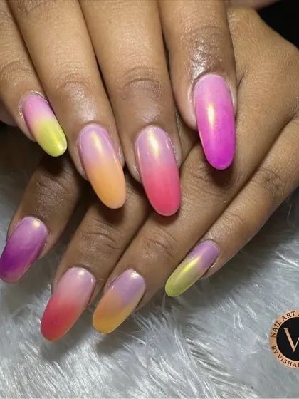 We love playing with color, and these vibrant ombré nails are a testament to that. This set showcases a flawless gradient of sunset hues, blending from fuchsia and orange to sunny yellow, finished with a pearlescent sheen for a magical, tropical vibe.