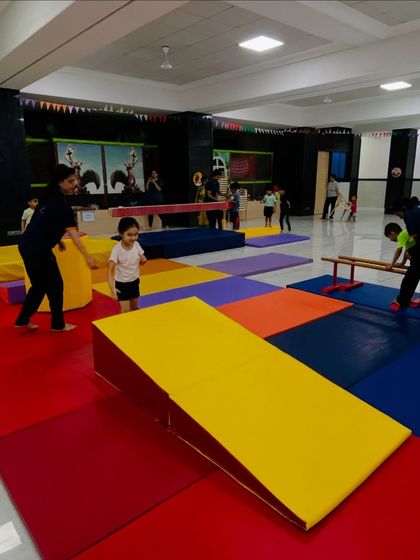 Our new Kandivali East center is a playground for building skills. Here, toddlers navigate a colorful obstacle course with wedges and mats, learning coordination and having fun under the watchful eye of our coaches.