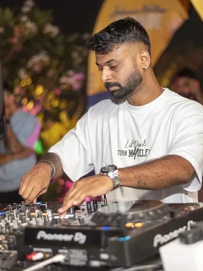 Another focused shot of me at the decks, ensuring the mix is perfect.