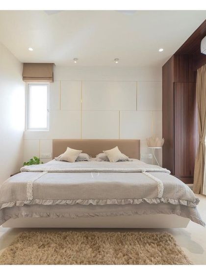 The master bedroom was designed as a serene, all-white sanctuary, a specific request from the clients. The space is filled with natural light, and the clean lines of the furniture and panelled headboard create a sophisticated and restful environment.