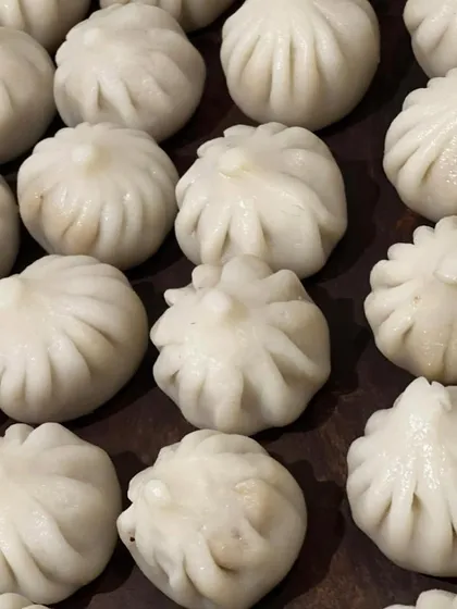 Perfectly pleated Ukadiche Modak, a traditional steamed sweet dumpling offered during the Ganesh Chaturthi festival.