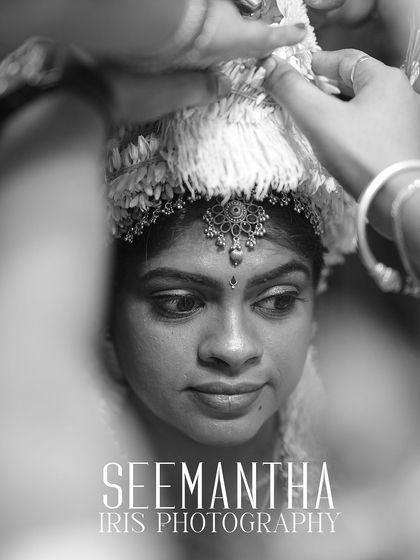 A powerful black and white photo of the mother-to-be during a Seemantha ritual. The focus is on her expression and the sanctity of the moment.
