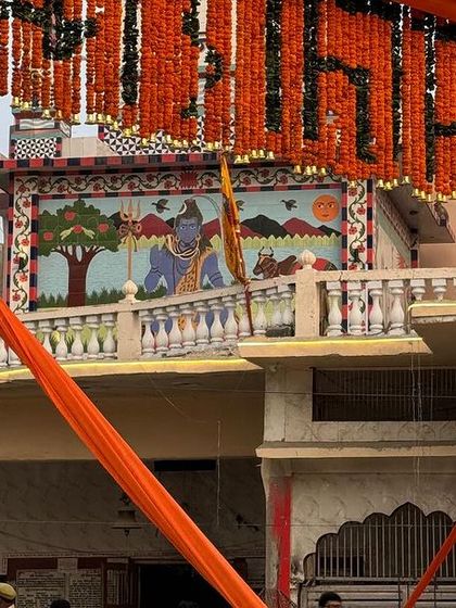 Looking up at a decorated archway in Ayodhya, with a temple mural visible in the background. Every corner of the city had a story to tell through its art and architecture.