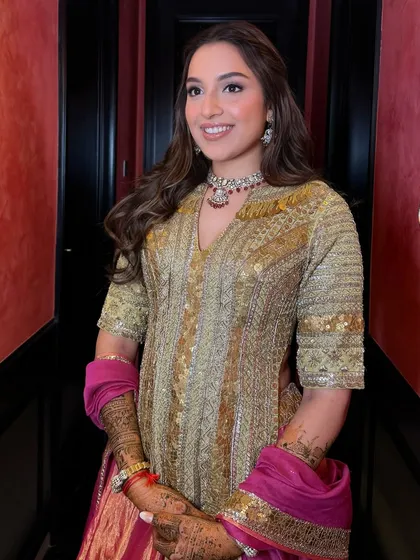 A full-length view of the Mehendi look, showing how the hairstyle complements the entire outfit.