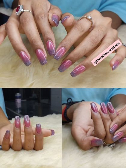 A beautiful set of long nails with a purple-to-pink glitter ombré effect.