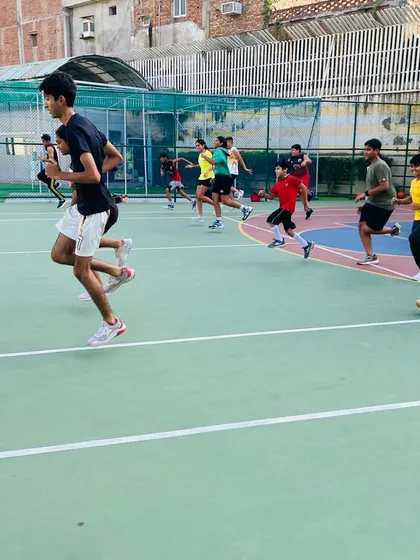 A group of players sprints down the court, showing the energy of our fitness sessions.
