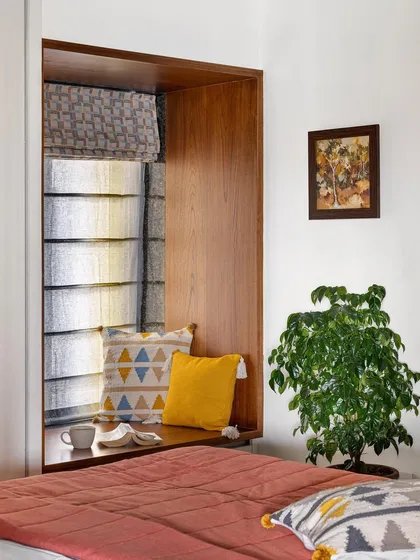 We have a love for bay windows, whether they exist or we create them. This cozy nook, framed in wood, was designed to be a peaceful retreat within the kids' room in our 'Gulmohar' project.