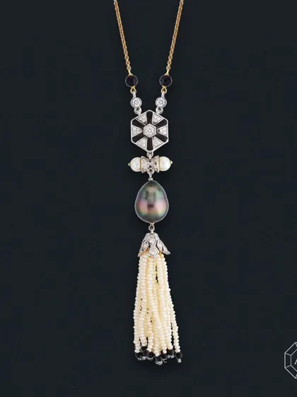 Crafted in a stunning lariat style, this necklace features 18Kt gold, round diamonds, South Sea pearls, a Grey Tahitian Pearl, and Onyx.