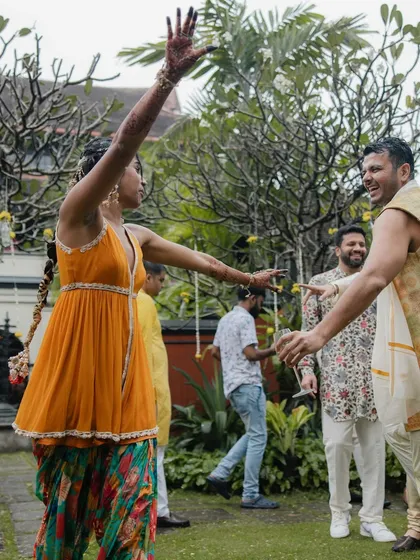 A candid moment of dance and celebration. The flowy patiala and comfortable top allowed the bride to move freely and enjoy every moment of her Haldi function.