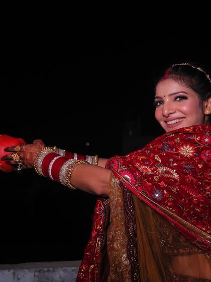 The traditional Karwa Chauth ritual. She looks absolutely radiant.