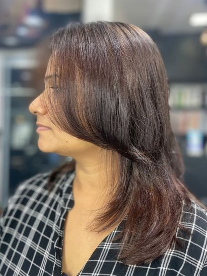 A sleek, layered haircut on medium-length hair, creating a polished and professional look.