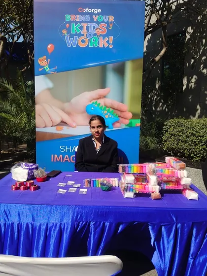 A clay modeling activity station set up for a corporate "Bring Your Kids to Work" day. It's a great way to provide structured, creative fun for children at corporate events.