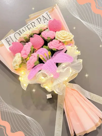 A close-up of our glowing pink bouquet. The combination of a large lily, tulips, and roses is made even more magical with the addition of fairy lights.