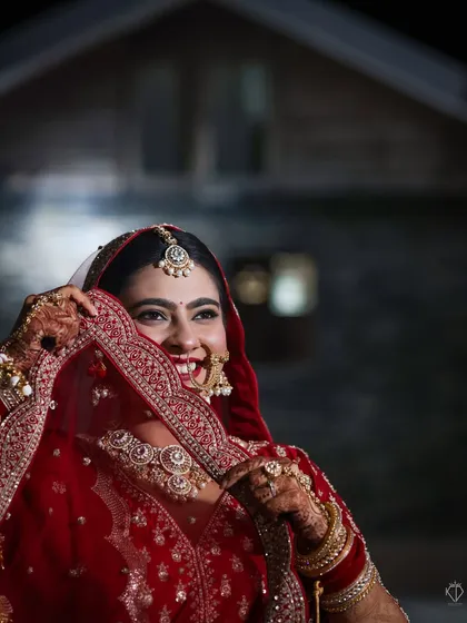 A candid moment of laughter, with the bride looking away from the camera. This natural shot, taken at night, feels intimate and full of life.