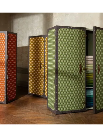 We encourage experimenting with textiles beyond their traditional uses. This Tuareg-inspired jacquard fabric, with its luxuriously thick and woolly texture, has been reimagined to cover wardrobe doors, adding unexpected pattern and tactile warmth to the room.