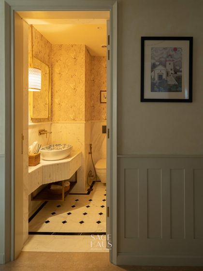 A peek into a powder room that balances style and personality. I used a patterned wallpaper, a custom-printed sink, and a classic black-and-white floor tile to create a space that is full of character.