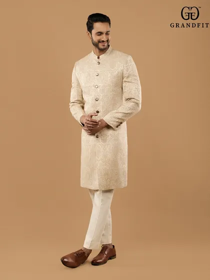 Our garments are designed not just for appearance, but for comfort and confidence. This candid shot captures the ease and perfect fit of a bespoke groom's sherwani in motion.